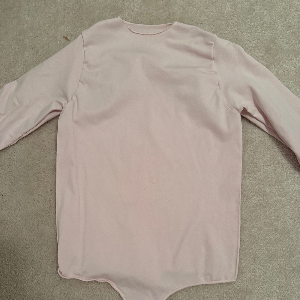 SKIMS raw hem long sleeve bodysuit in baby pink